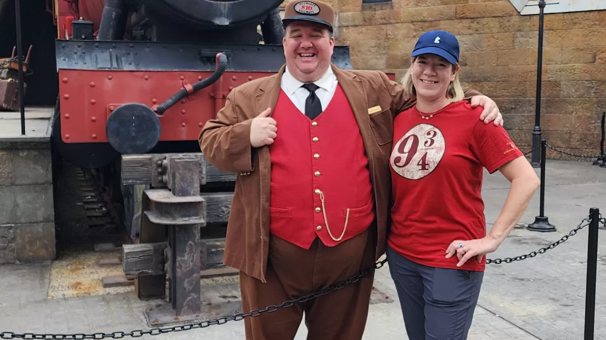 Jessica Yashin and the train conductor at the Wizarding World of Harry Potter