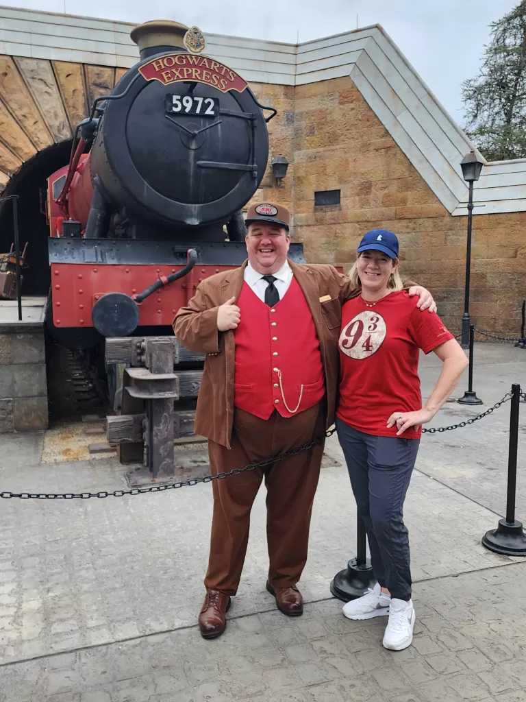 Jessica Yashin and the train conductor at the Wizarding World of Harry Potter